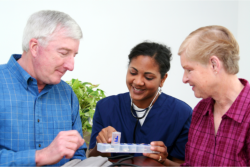 caregiver reminding patients of their medications