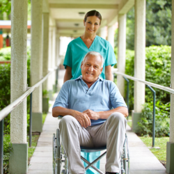 caregiver giving a push to a client on a wheel chair