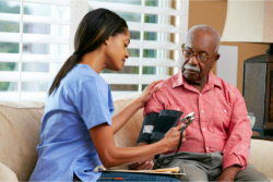 caregiver taking patients blood pressure